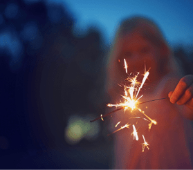 Shot of a unrecognizable little girl playing with a sparkler at night time outside in nature 