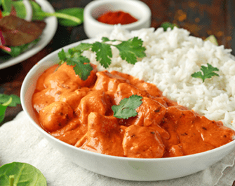 Chicken tikka masala curry with rice and naan bread 