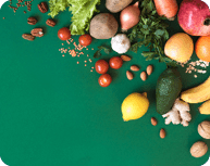 Healthy vegan food assortment. Organic vegetarian food ingredients vegetables and fruits on green background, copy space, banner. Clean vegan eating and detox concept.