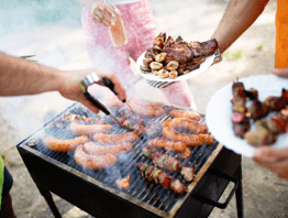 Group of friends camping and having a barbecue in nature