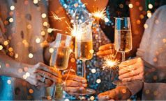 Friends celebrating Christmas or New Year's eve with Bengal lights and champagne.  