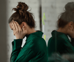 Young sad woman in office, having troubles.
